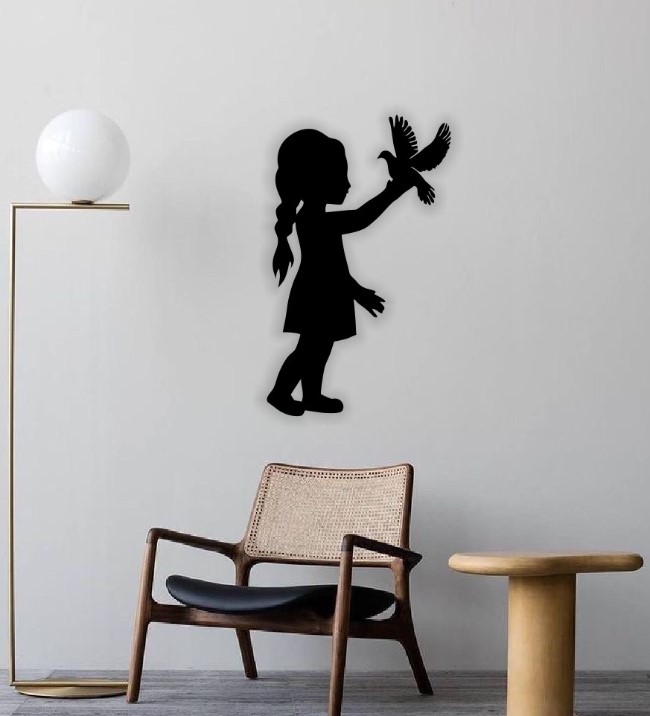 Little girl with bird wall decor